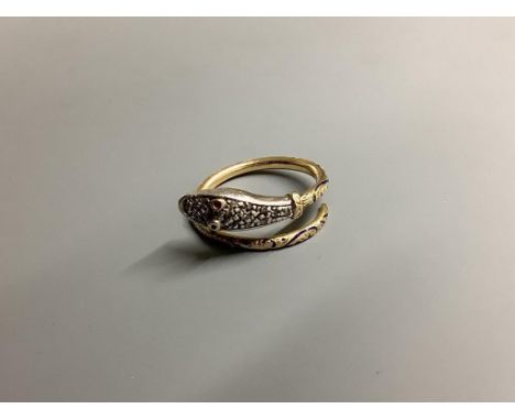 A yellow metal, blue enamel(a.f.) ruby and diamond chip set serpent ring, size L, gross 4.5 grams.
