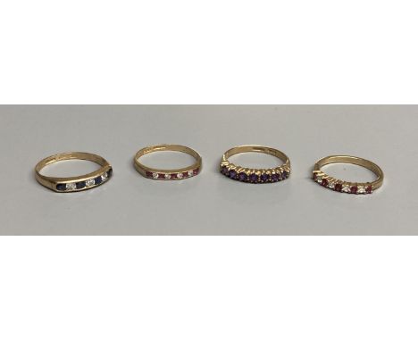 A modern 9ct gold, ruby and diamond set half hoop ring  and a similar amethyst ring and two other 9ct gold gem set rings,gros