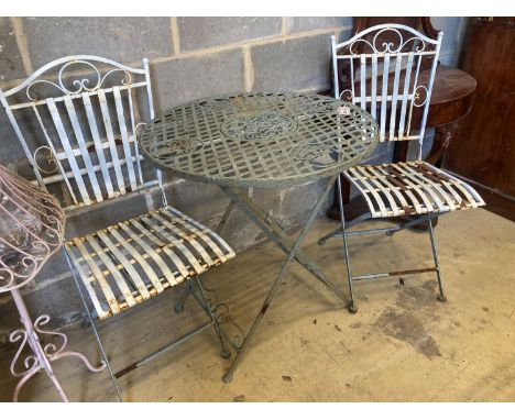 A painted circular aluminium folding garden table, 71cm diameter, height 76cm, together with a pair of folding garden chairs