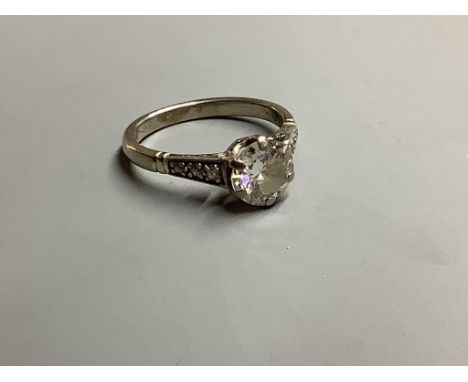 An 18ct, white metal and single stone diamond ring, with diamonds set shoulders, size M, gross weight 3.9 g,The stone weighin