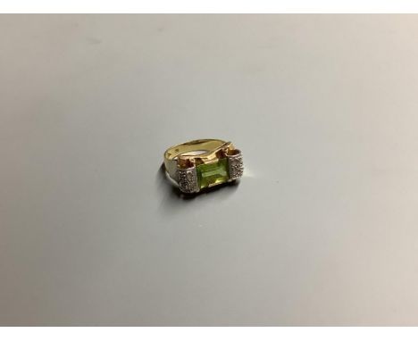 A 1950's? 750 yellow metal, peridot and diamond set dress ring, size O, gross 6.9 grams.