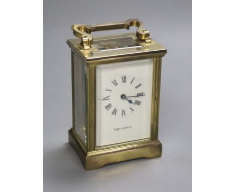 An early 20th century brass carriage timepiece, retailed by Mappin &amp; Webb Ltd, black Roman numerals on a white dial, 8cm 