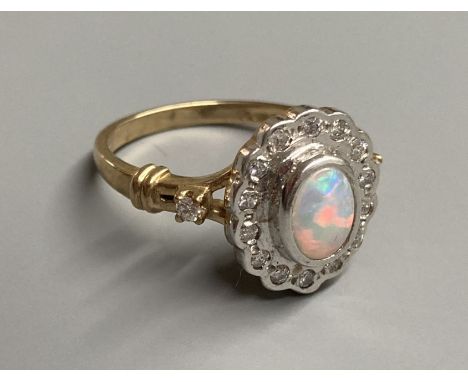 A modern 9ct gold, white opal and diamond  chip set cluster ring, with diamond set shoulders, size O, gross 4.4 grams.