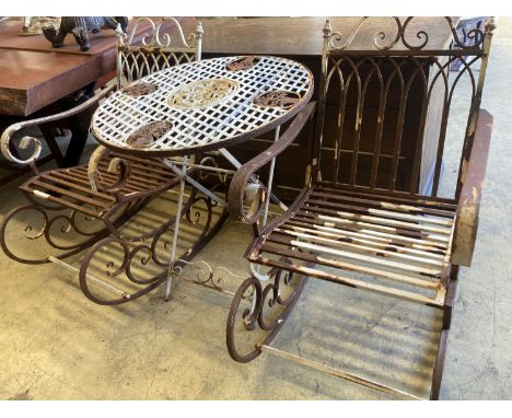 A pair of painted wrought iron garden rocking chairs together with a circular wrought iron folding garden table, diameter 71c