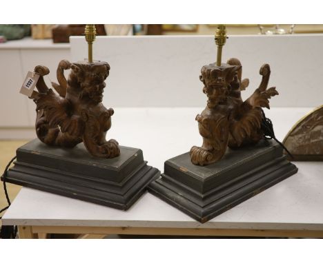A pair of carved walnut winged griffin table lamps, 40cm high excl. light fitting
