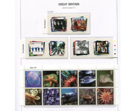 A collection of Great Britain stamps, decimal mint commemoratives and definitives in ten albums up to 2011 plus three year bo