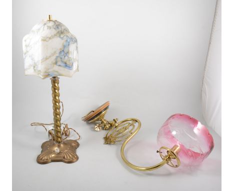 Brass oil lamp wall bracket, adapted for electricity, tinted cranberry shade, depth 46cm; and a 1920s style brass table lamp,