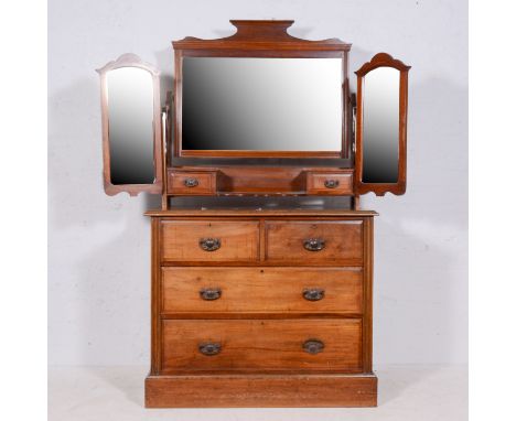 Late Victorian walnut dressing chest, triptych mirrors over with two raised trinket drawers and a serpentine shelf, the base 