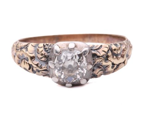 A George III diamond single stone ring, featuring a cushion shape old cut diamond in a cut down setting, with chased floral d