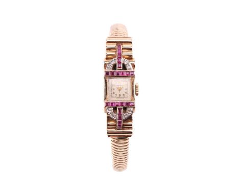 An Emka ruby and diamond set dress watch, featuring a Swiss-made hand-wound movement in a yellow metal case stamped '375' and