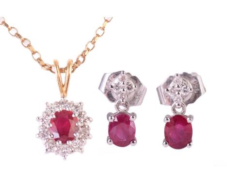 A ruby and diamond cluster pendant, the central ruby measuring 5.7 x 5.2mm, encircled by round brilliant cut diamonds with a 