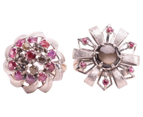 Two floral cocktail rings set with ruby and black star sapphire; the first centred with a round black star sapphire cabochon 