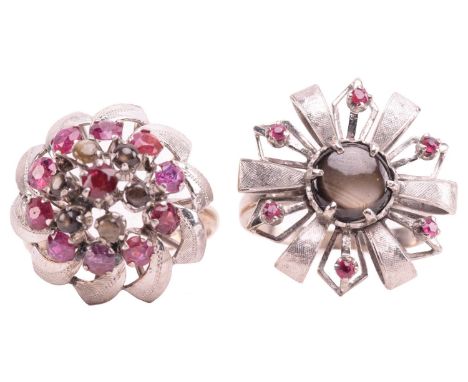 Two floral cocktail rings set with ruby and black star sapphire; the first centred with a round black star sapphire cabochon 