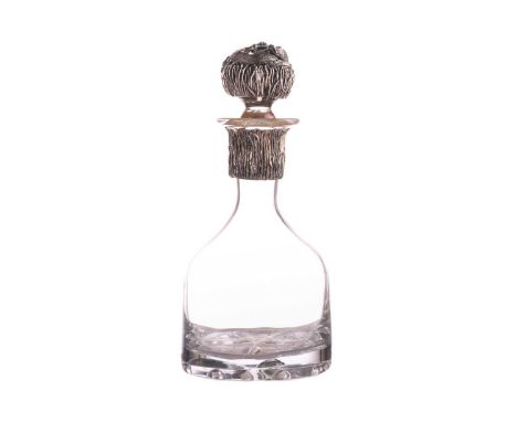 An unusual Australian novelty decanter set with an opal. The dimpled bell-shaped plain glass body with a white metal collar i