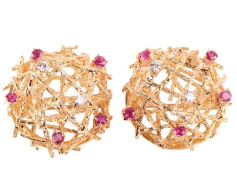 A pair of Modernist ruby and diamond brooches; circular, each set with two round brilliant cut diamonds and five circular-cut