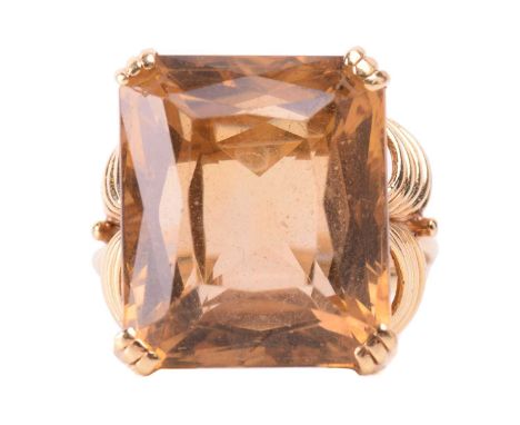 A single stone citrine dress ring, the large rectangular mixed cut, cut-cornered citrine in ribbed corner claw mounts, the st