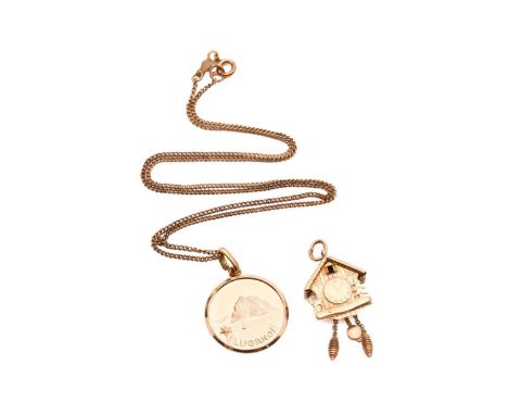 A cuckoo clock charm and a pendant on chain; the charm in the form of a cuckoo clock, with articulated weights and a pendulum