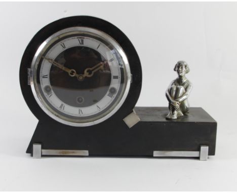 A 1930s Art Deco Westminster chime mantel clock, ebonised case incorporating a chrome figurine of a seated girl, standing on 