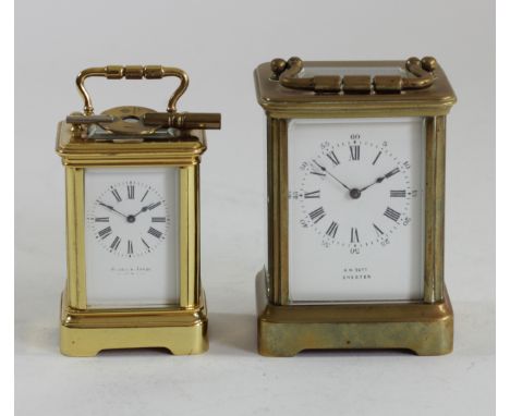 A miniature gilt brass carriage time piece, white enamel dial, 7.5 x 5 x 4.5cm and another small brass carriage time piece, t