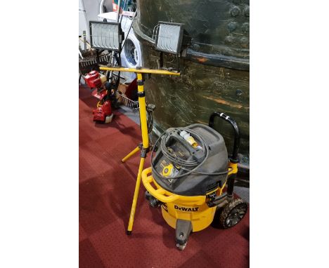 A DeWalt DWV902M vacuum, with bags (missing hose) together with a GS Model WL1K work light, power cable, two lights on a powd