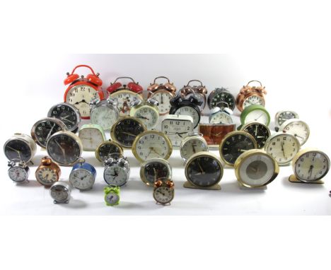 A large collection of mid 20th Century and later manual wind &amp; quartz travel/bedside alarm clocks. (3) 