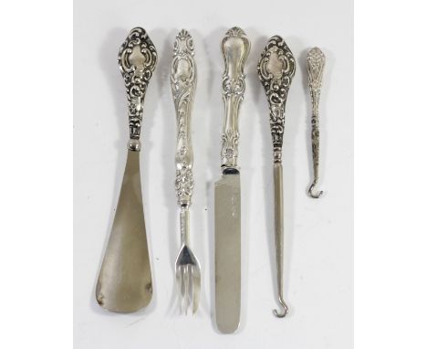 A silver handled button hook and shoe horn, Chester 1910, a small button hook, Birmingham 1911 and a Victorian silver christe