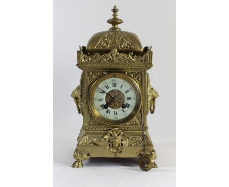 A late 19th century ornate cast brass mantel clock, off white enamel chapter ring with Roman numerals, the signed Japy Freres
