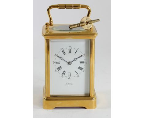 Winder, Eastbourne, a gilt brass Corniche cased striking carriage clock, white enamel dial with Roman numerals, the unsigned 