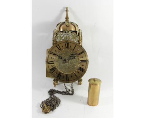 A Victorian&nbsp;Hook &amp; Spike Brass Lantern Clock, the strapped bell over urn finials and foliate fret, the tapered colum