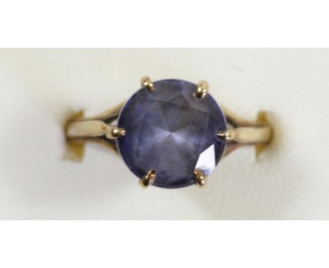 A 9ct gold and synthetic sapphire single stone ring, diameter 10mm, O 1/2, 4.1gm 