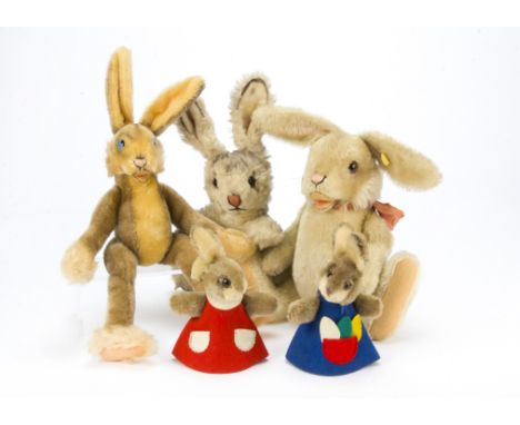 Five post-war Steiff rabbits, A Lulac Floppy Rabbit —14in. (35.5cm.) high, a large jointed Niki Rabbit with button and yellow