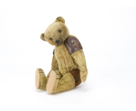 A rare and unusual Farnell teddy bear 1910-1920s, With blonde mohair, flat black boot button eyes, pronounced muzzle, black s