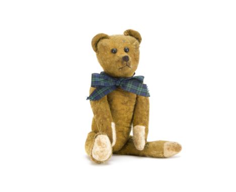 A German teddy bear 1920s, Possibly Schuco with short golden mohair, black boot button eyes, pronounced muzzle, black stitche