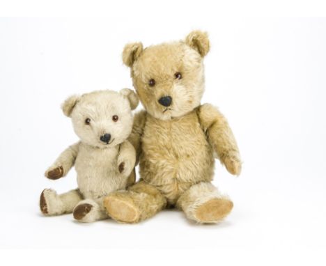 Two post-war Chiltern Hugmee teddy bears,  the larger with blonde mohair, orange and black plastic eyes, black plastic nose, 