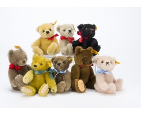 Eight small Steiff yellow-tagged teddy bears, Including a black and pink example —7½in. (19cm.) highest (missing chest tags)