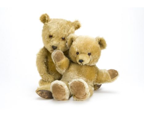 A post-war Chiltern Hugmee teddy bear, with golden mohair, orange and black glass eyes, black stitched nose, mouth and claws,