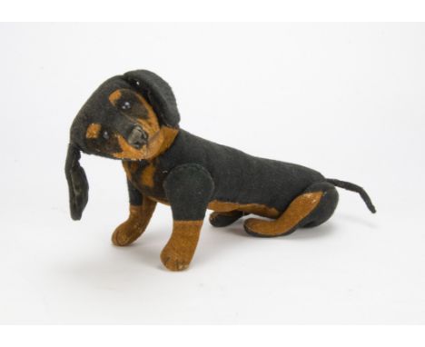 A Steiff jointed dachshund circa 1910, Of black and brown burlap, black boot button eyes, black stitched nose, mouth and claw