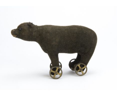 A very early and rare German bear on wheels probably Steiff, With black burlap plush, black boot button eyes, pink or white s