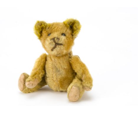 An unusual American teddy bear 1910s-1920s, with golden mohair, black boot button eyes, thick brown cord stitched nose and mo
