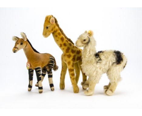 Three post-war Steiff wild animals, A velvet Okapi with chest tag —10¼in. (26cm.) high; a Llama and Giraffe with buttons 