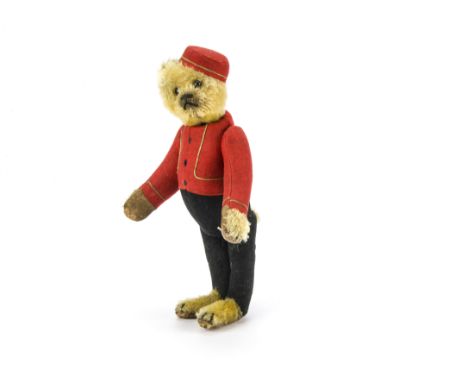 A rare Schuco Bellhop yes/no teddy bear 1920s,  With golden mohair head, hands, feet and tail, black boot button eyes, black 