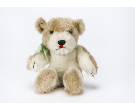 A post-war Chiltern dog, With beige and white mohair, orange and black glass eyes, leather nose, felt tongue, hinged limbs fo