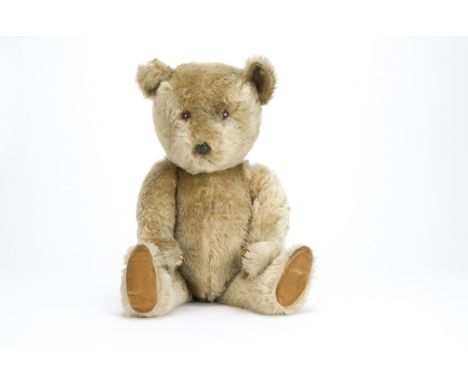 A large post war Chiltern Hugmee teddy bear,  With blonde mohair, orange and black plastic eyes, black plastic nose, black st