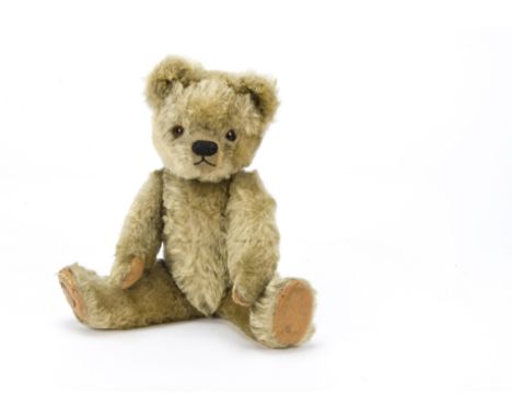 A Chad Valley teddy bear 1940s, With blonde mohair, orange and black glass eyes, black stitched nose and mouth swivel head, j