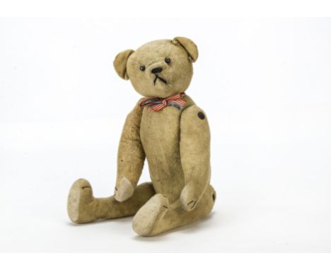 A French brushed cotton teddy bear circa 1918, With boot button eyes, black stitched nose, mouth and claws, swivel head, pin-