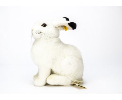 A Steiff yellow tagged Hoppel Blue Hare,  Seated with chest tag and a Steiff box —14in. (35.5cm.) high