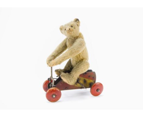 A rare Steiff Urteddy teddy bear on clockwork trolley, With pale golden mohair, brown and black glass eyes, pronounced muzzle