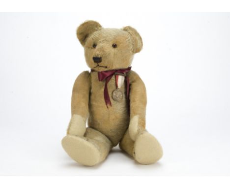 A British  teddy bear 1920s, Probably Chad Valley with golden mohaIr, orange and black glass eyes, pronounced muzzle, black s