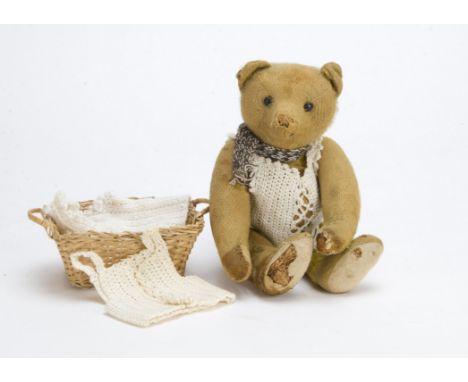 An early German teddy bear circa 1910, With short golden mohair, black boot button eyes, pronounced muzzle, elongated limbs w