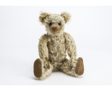 An early Farnell teddy bear 1910-1920s,  With blonde mohair, black boot button eyes, pronounced muzzle, brown stitched nose, 